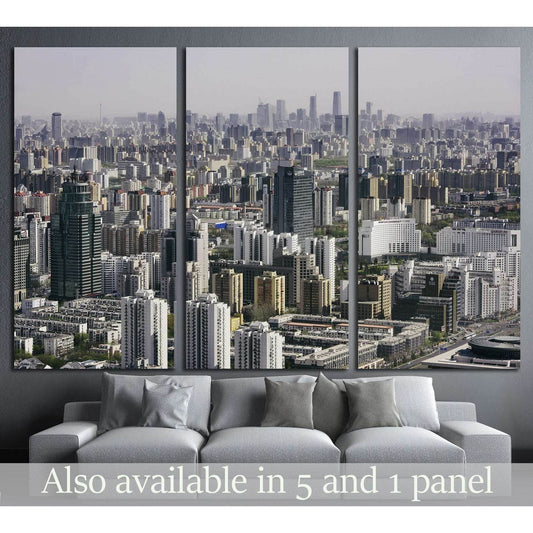 Beijing skyline triptych canvas print with dense residential towers above a sofa in a modern living room