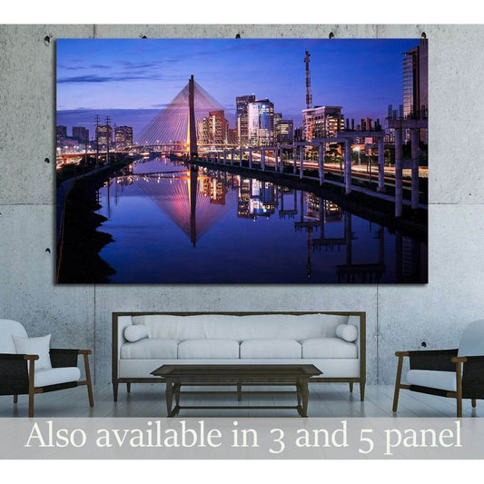 Sao Paulo skyline canvas print with Octavio Frias bridge at dusk above a sofa in a modern living room