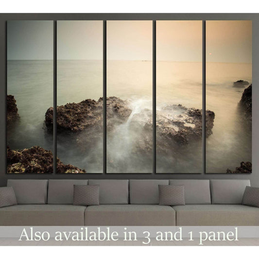 Goa seascape canvas print with rocky shore and soft long-exposure water above a sofa