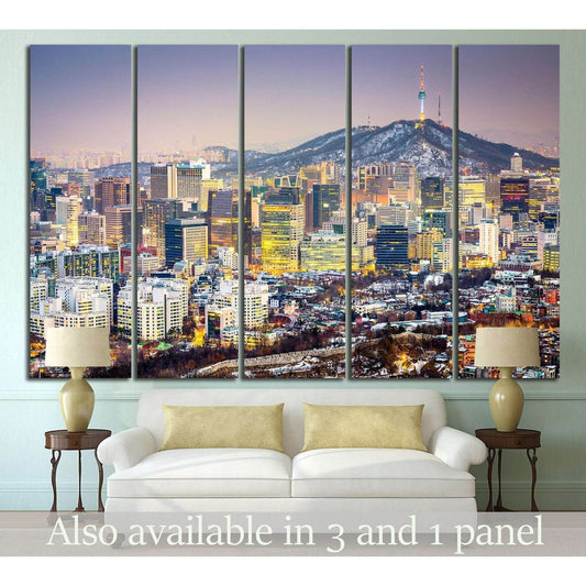 Seoul skyline canvas print with Namsan Tower at dusk, displayed above a sofa in a modern living room