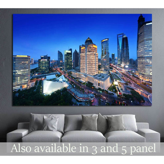 Shanghai skyline canvas print with illuminated skyscrapers at night above a modern sofa