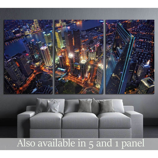 Shanghai skyline triptych canvas print with neon skyscrapers above a sofa in a modern living room