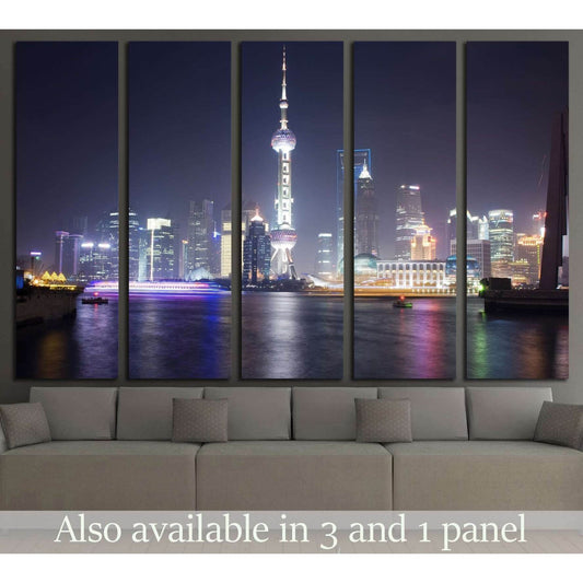 Shanghai skyline canvas print with Oriental Pearl Tower at night, displayed above a sofa in a modern living room