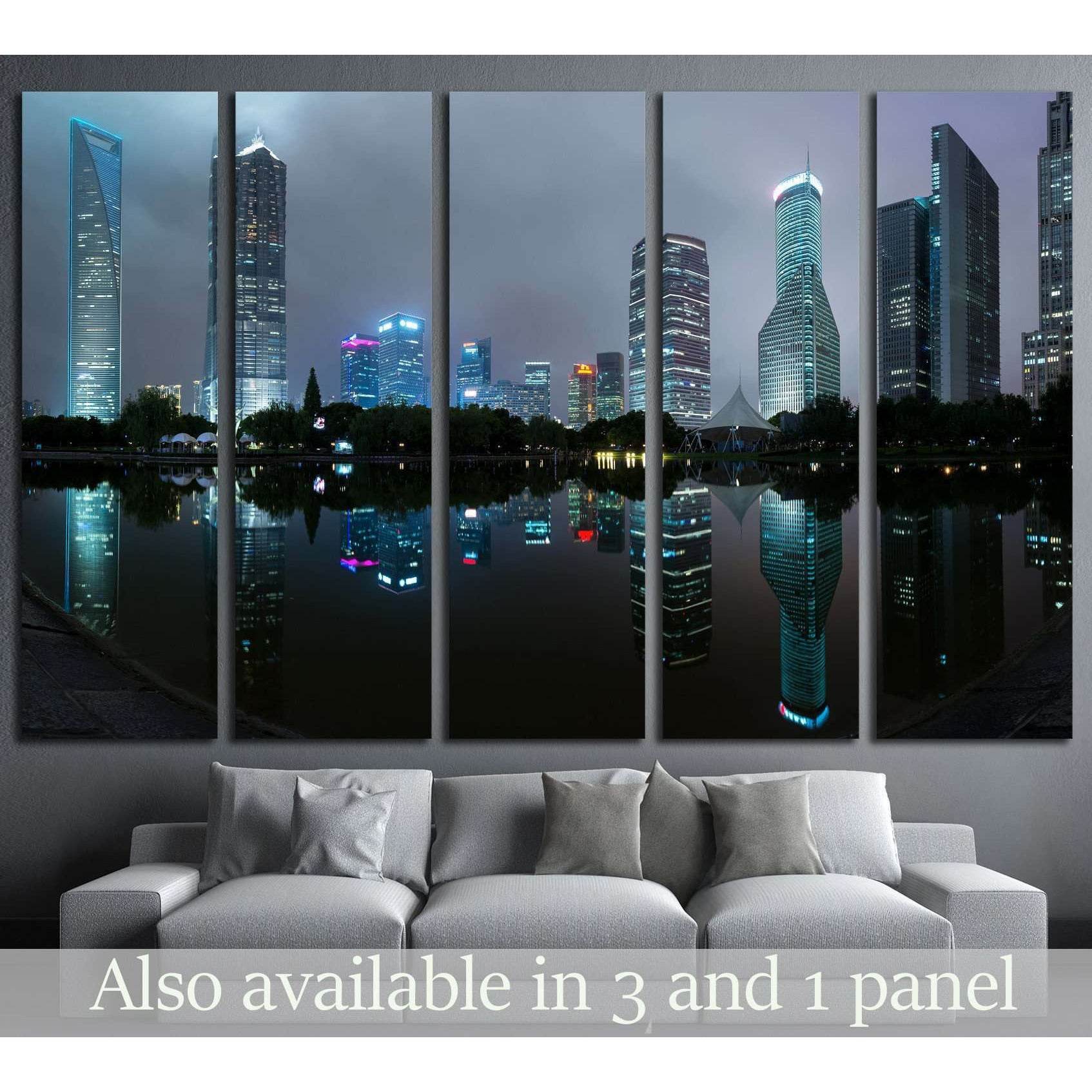 Shanghai skyline canvas print with illuminated skyscrapers reflected in calm water at dusk