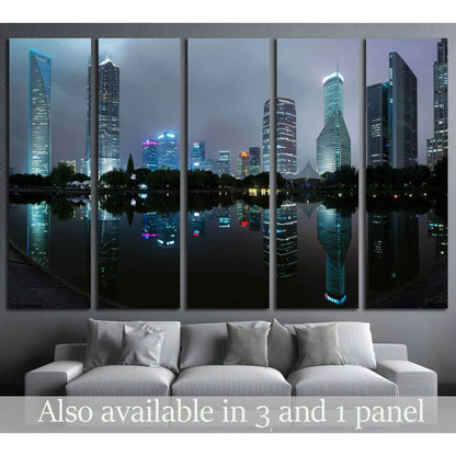 Shanghai skyline canvas print with illuminated skyscrapers reflected in calm water at dusk