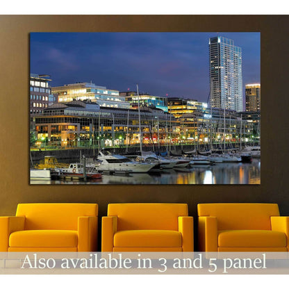 Buenos Aires skyline canvas print above yellow chairs with marina lights and sailboats at dusk