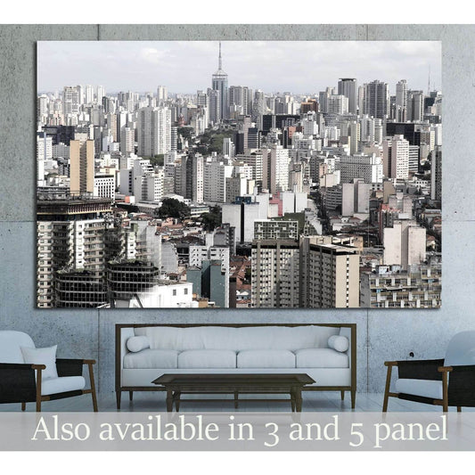 São Paulo skyline canvas print with dense gray high-rise cityscape above a sofa in a modern living room