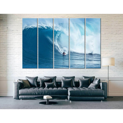 Big wave surfing canvas print with surfer under a curling blue wave above a sofa in a modern living room