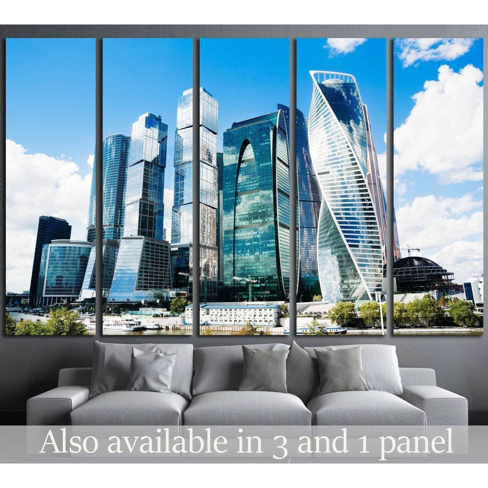 Moscow City skyline canvas print in five-panel mockup above sofa with blue skyscrapers and riverfront