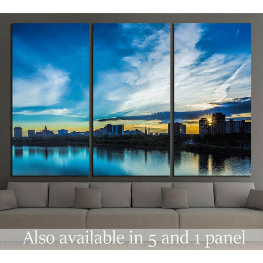 Saskatoon skyline sunset canvas print above sofa with river reflections in a modern living room