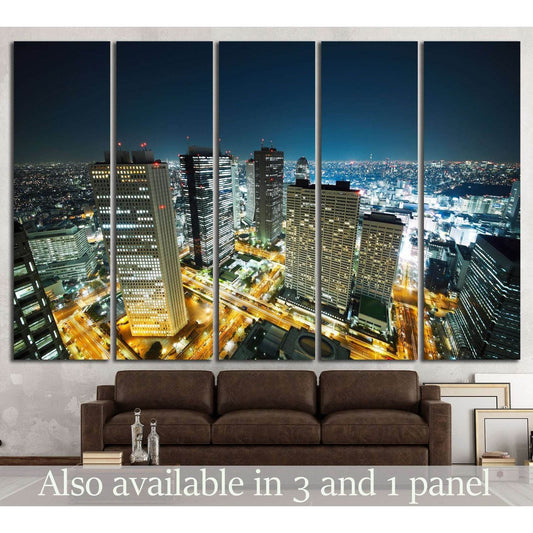 Tokyo skyline canvas print with glowing night city lights, displayed above a brown sofa