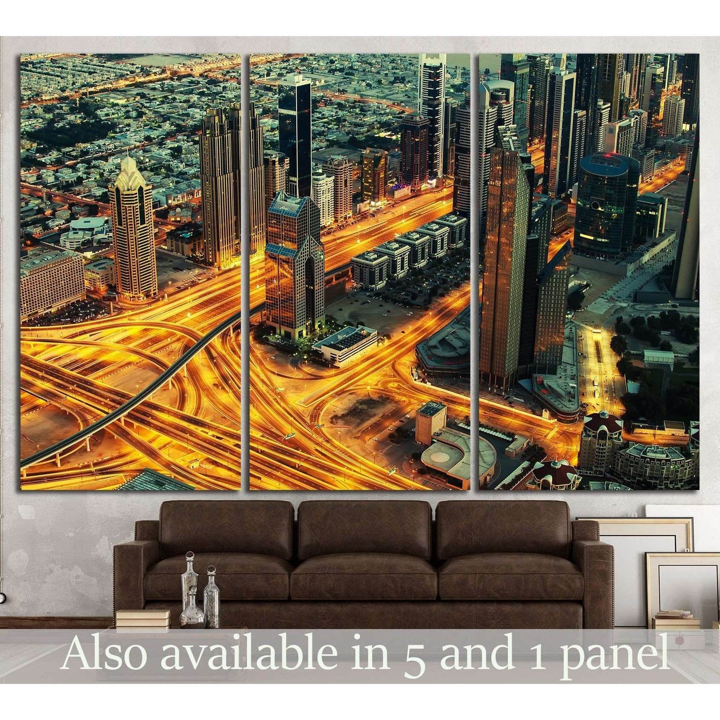 Dubai night skyline canvas print above sofa with glowing highway interchanges and skyscrapers
