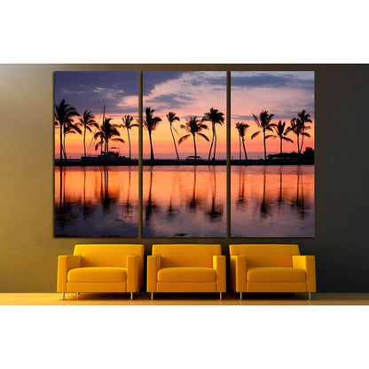 Tropical Sunset and Palm Trees Canvas Print for Coastal Wall DecorThis canvas print beautifully captures a tropical sunset with silhouetted palm trees against a vibrant sky. The reflections on the calm water create a symphony of colors, ideal for bringing