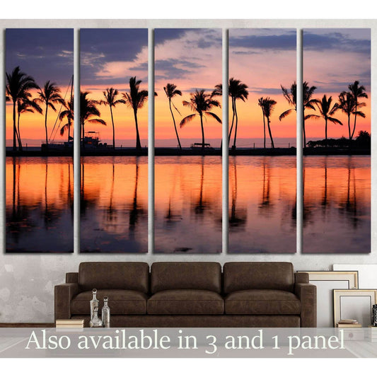 Tropical Sunset and Palm Trees Canvas Print for Coastal Wall DecorThis canvas print beautifully captures a tropical sunset with silhouetted palm trees against a vibrant sky. The reflections on the calm water create a symphony of colors, ideal for bringing