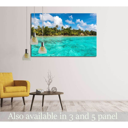 Bora Bora lagoon canvas print with turquoise water, palm-lined shore, and blue sky in a modern living room