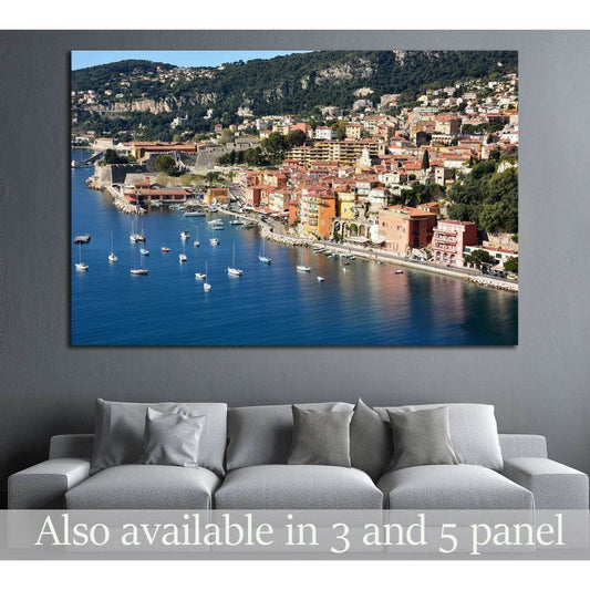 Villefranche-sur-Mer harbor canvas print with blue bay, sailboats, and colorful French Riviera waterfront above a gray sofa