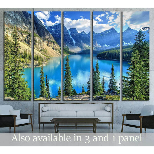 Moraine Lake and Wenkchemna Peaks Canvas Print - Majestic Landscape Wall ArtThis canvas print captures the stunning Wenkchemna Peaks reflected on the serene Moraine Lake, with its vibrant turquoise waters surrounded by verdant evergreens. The majestic mou